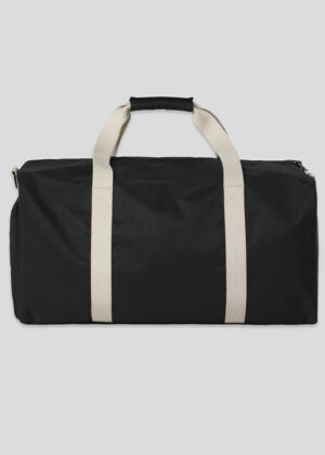 Black duffel bag with beige webbing handles, shown laying flat against a light background for travel gear use.