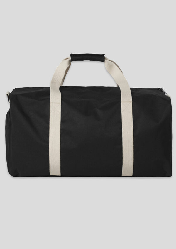 Black duffel bag with beige webbing handles, shown laying flat against a light background for travel gear use.