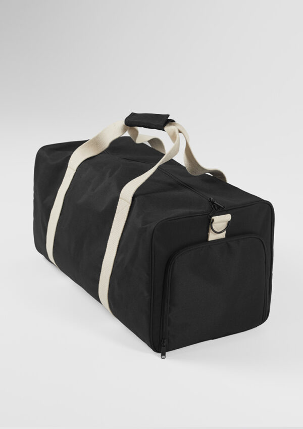 Black duffel bag with beige carrying straps and a front zippered pocket on a light background.