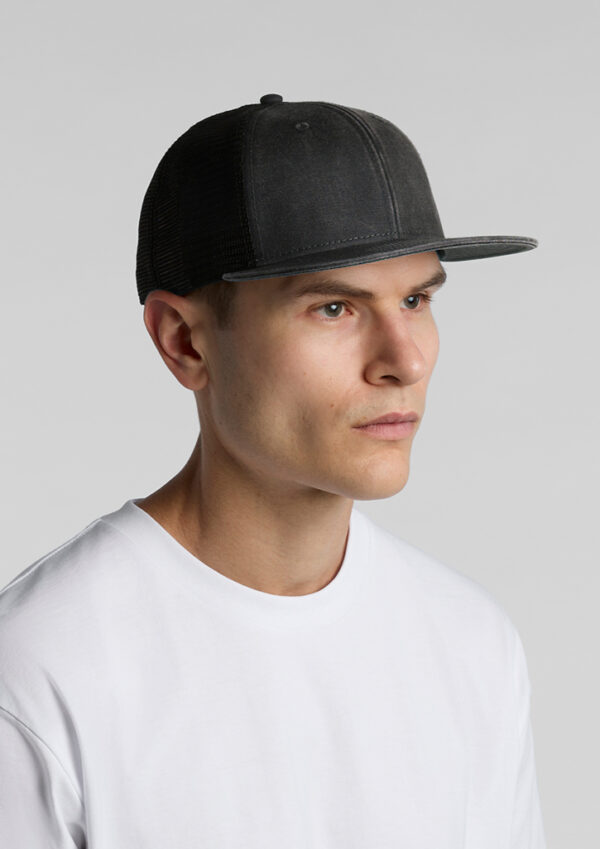 Man wearing a black mesh-back baseball cap in profile view against a gray background, with a white T-shirt.
