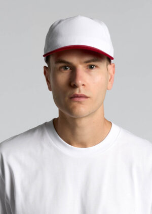 Man wearing a white cap with a red brim and a white shirt against a light gray background, facing forward.