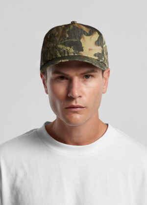 Man wearing a woodland camouflage baseball cap and a white crewneck T-shirt, facing the camera.