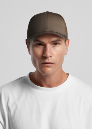 Man wearing a brown baseball cap and white T-shirt against a neutral gray background, looking straight ahead, serious expression.