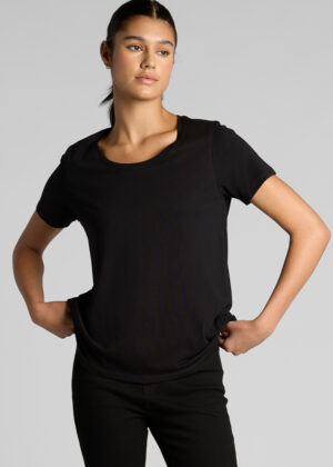 Model wearing a plain black short-sleeve t-shirt and black pants, standing with hands on hips against a light gray background.
