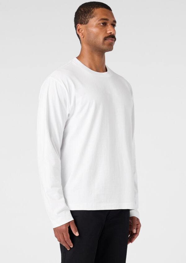 Man in a white long-sleeve shirt, shown in profile against a light background.