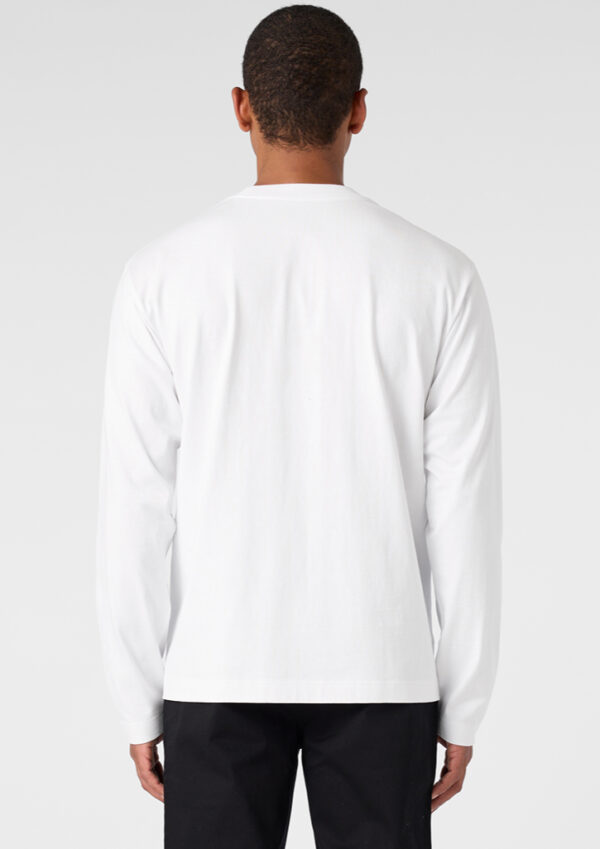 Back view of a person wearing a plain white long-sleeve shirt and black pants against a light gray background.