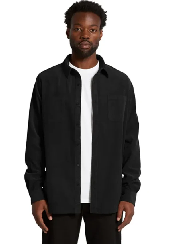 as5419_worn_00 Man wearing a black button-up shirt over a white t-shirt, standing facing the camera against a white background.