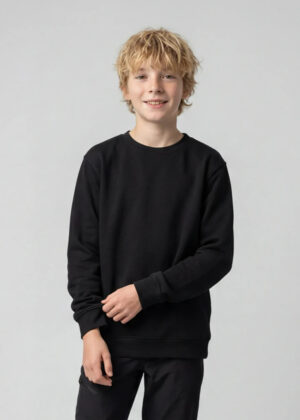 A smiling boy with blond hair wearing a black sweatshirt and black pants against a light gray background.