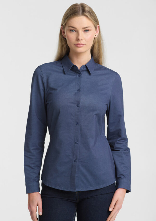 Model wearing a blue button-down shirt with long sleeves against a light gray background, front view.