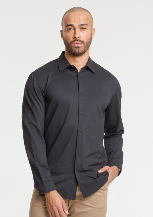Male model wearing a dark gray long-sleeve button-down shirt with khaki pants, facing the camera against a light background, product-style shot.