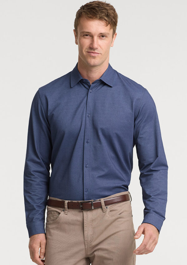 Man modeling a blue button-down shirt tucked into tan chinos with a brown belt, front view.