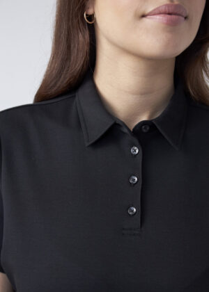 Close-up of a person wearing a black polo shirt with four black buttons and a visible collar, partial face shown.