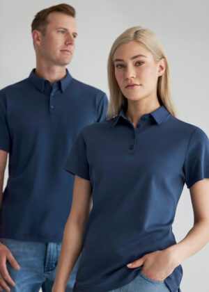 Two adults modeling navy polo shirts; woman in front, man standing behind to the left.