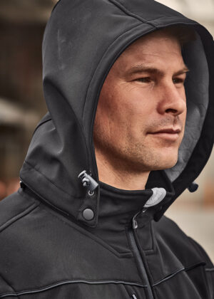 Man in a black hooded jacket, viewed in profile, looking to the right.