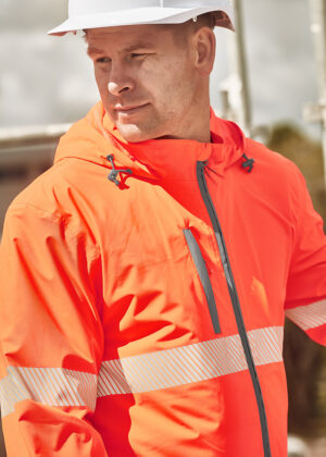 Construction worker in a bright orange safety jacket with reflective stripes and a white hard hat, looking to the side.