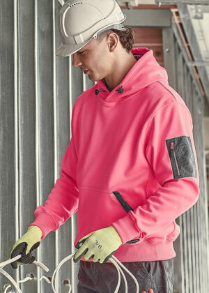 Construction worker in a pink hoodie and hard hat handling white electrical cables at a construction site