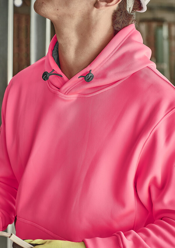 Close-up of a person wearing a bright pink hoodie with dark gray drawstrings, shown from the chest up.