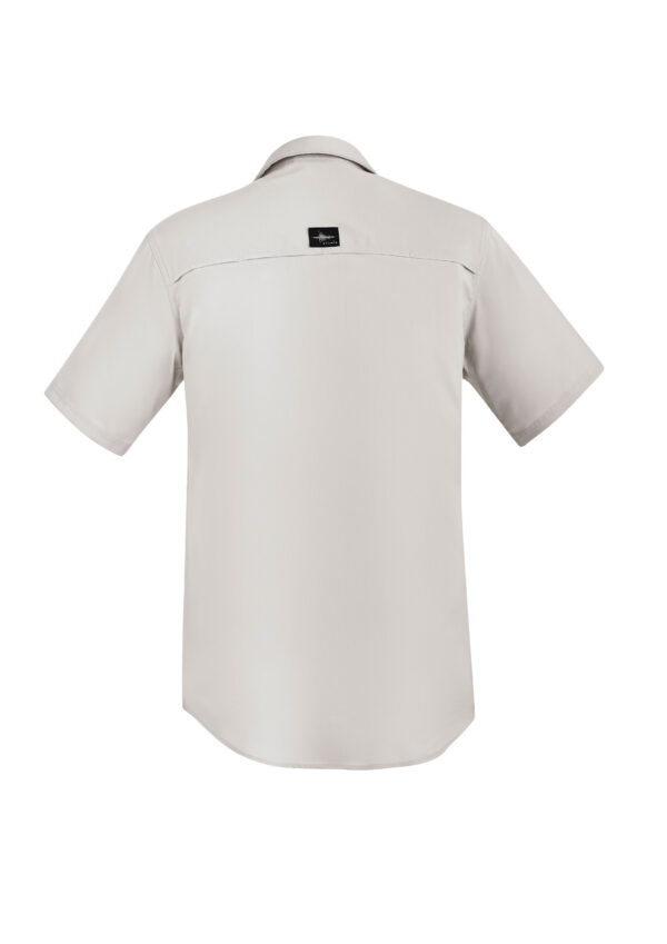 Back view of a light beige short-sleeve shirt, collared, with a small black brand label on the upper back.